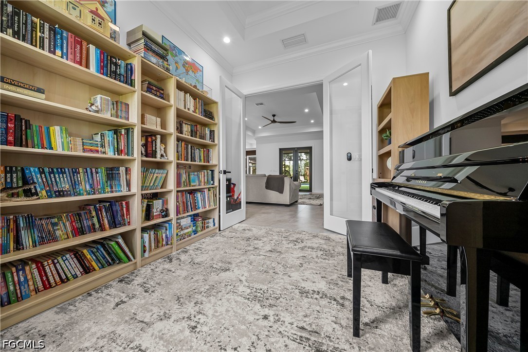 4498 8th Street Northeast Naples, FL 34120 - Photo 15 of 49 a livingroom with a book shelf and a book shelf