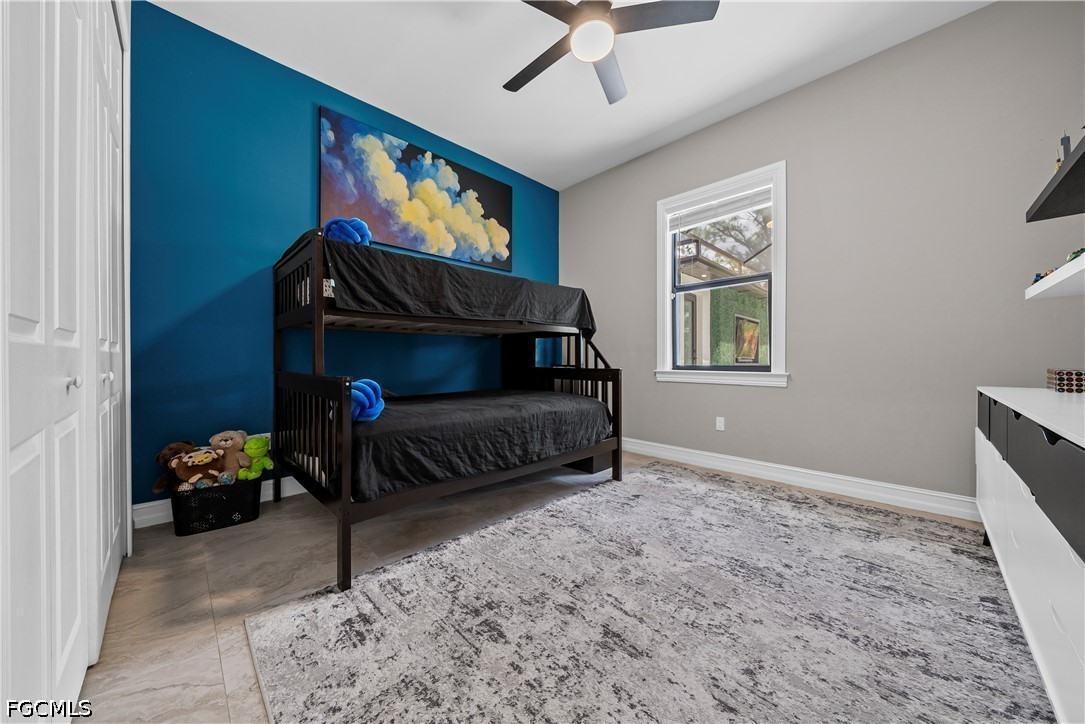 4498 8th Street Northeast Naples, FL 34120 - Photo 16 of 49 a living room with furniture a flat screen tv and a window