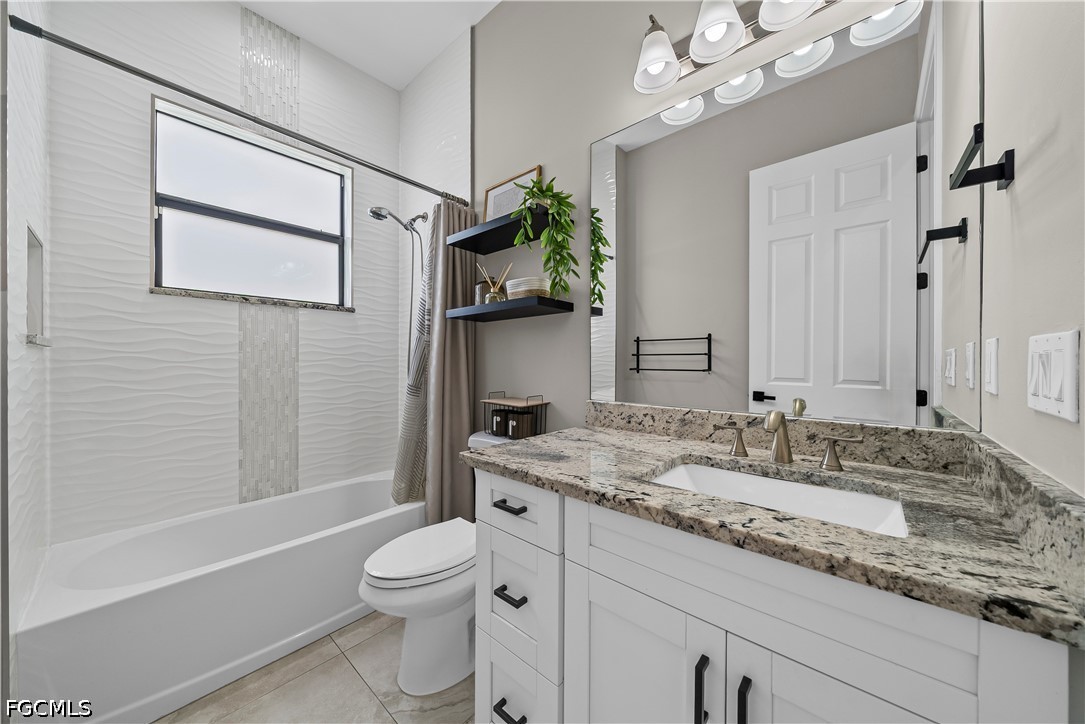 4498 8th Street Northeast Naples, FL 34120 - Photo 17 of 49 a bathroom with a granite countertop sink a toilet and bathtub
