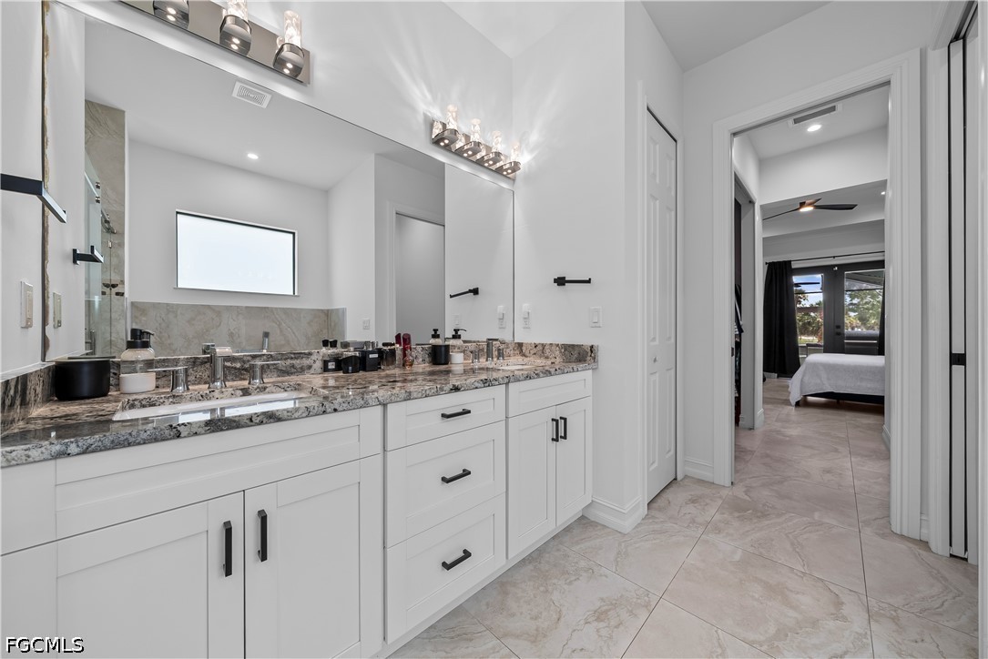 4498 8th Street Northeast Naples, FL 34120 - Photo 21 of 49 a spacious bathroom with a granite countertop sink mirror and
