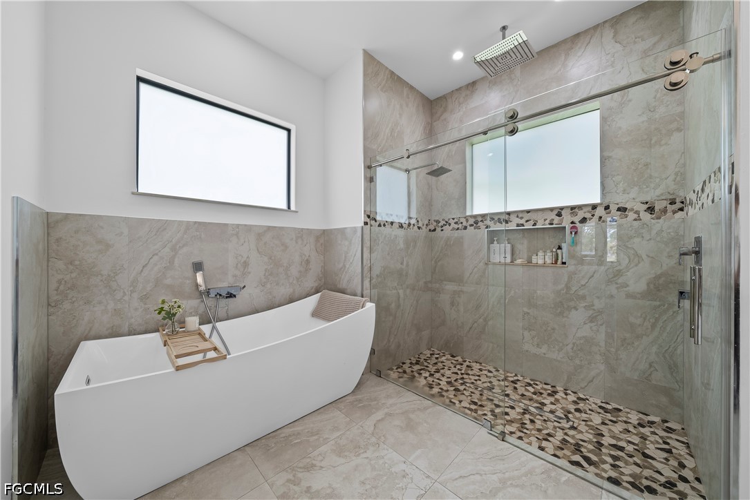 4498 8th Street Northeast Naples, FL 34120 - Photo 22 of 49 a bathroom with a bathtub and shower