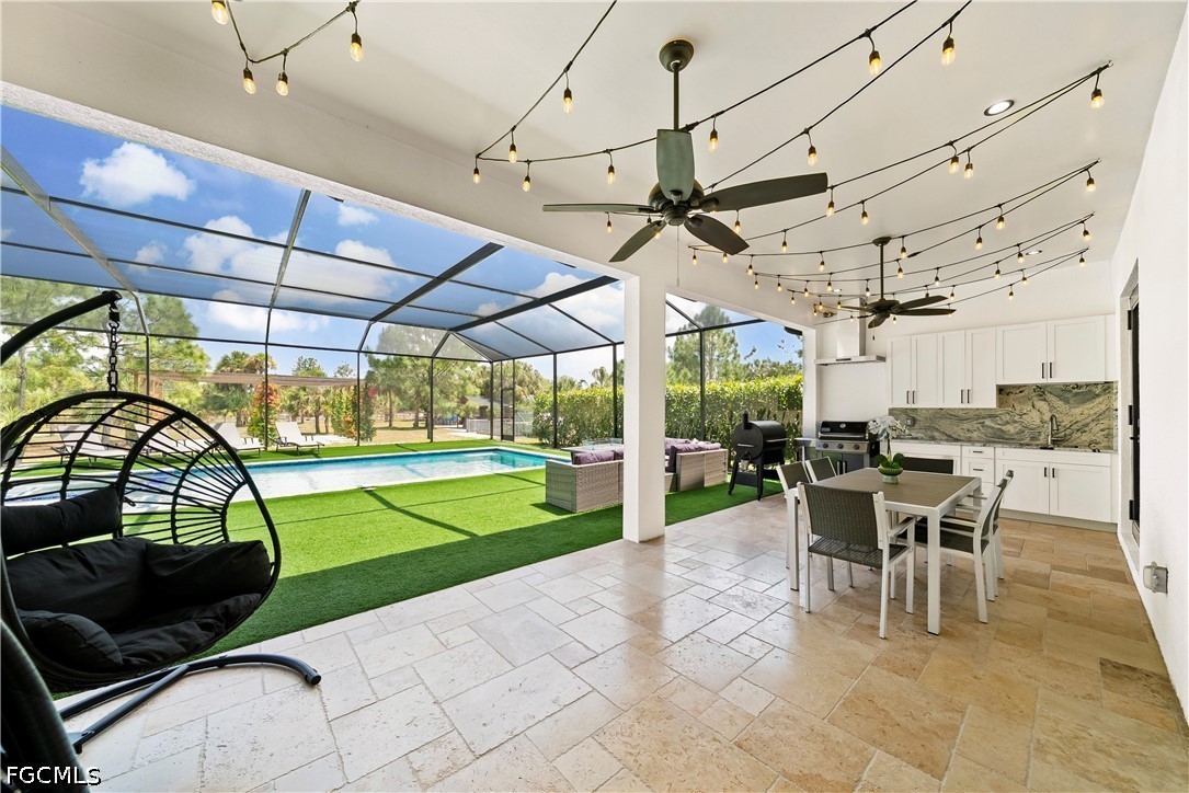 4498 8th Street Northeast Naples, FL 34120 - Photo 26 of 49 a view of a patio with a dining table and chairs