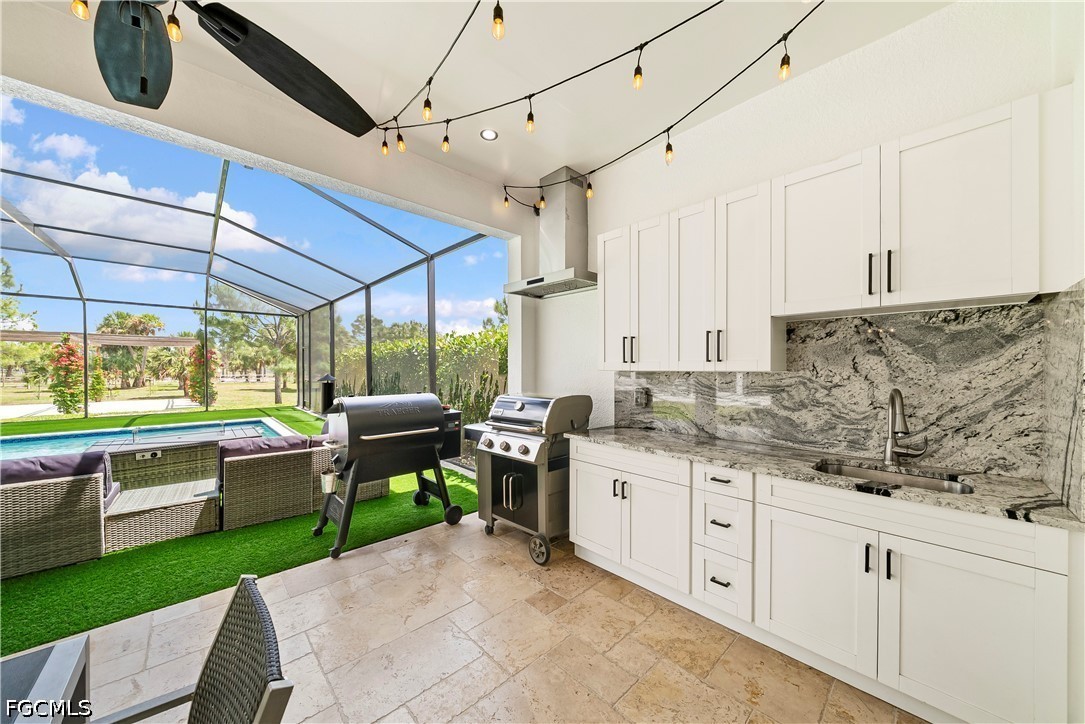 4498 8th Street Northeast Naples, FL 34120 - Photo 27 of 49 a kitchen with kitchen island a white cabinets and wooden floor