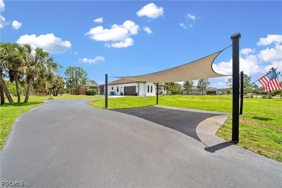 4498 8th Street Northeast Naples, FL 34120 - Photo 48 of 49 a view of a house with a backyard porch and sitting area