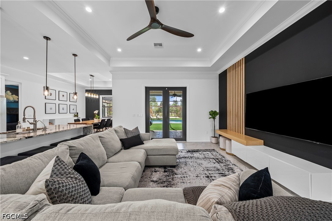 4498 8th Street Northeast Naples, FL 34120 - Photo 7 of 49 a living room with furniture and a flat screen tv