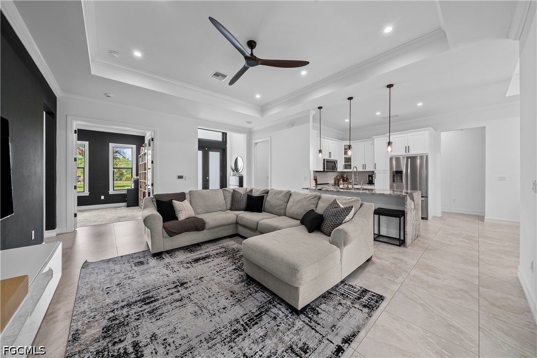 4498 8th Street Northeast Naples, FL 34120 - Photo 8 of 49 a living room with furniture and kitchen view
