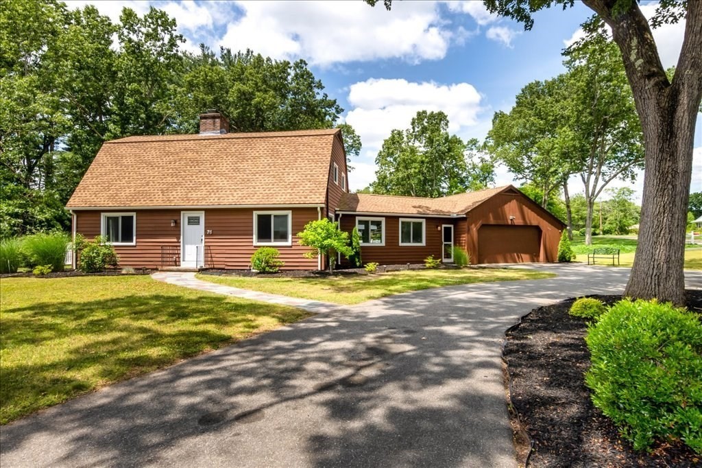 76 Woodland Road Longmeadow, MA 01106 - Photo 1 of 42 a front view of a house with a garden