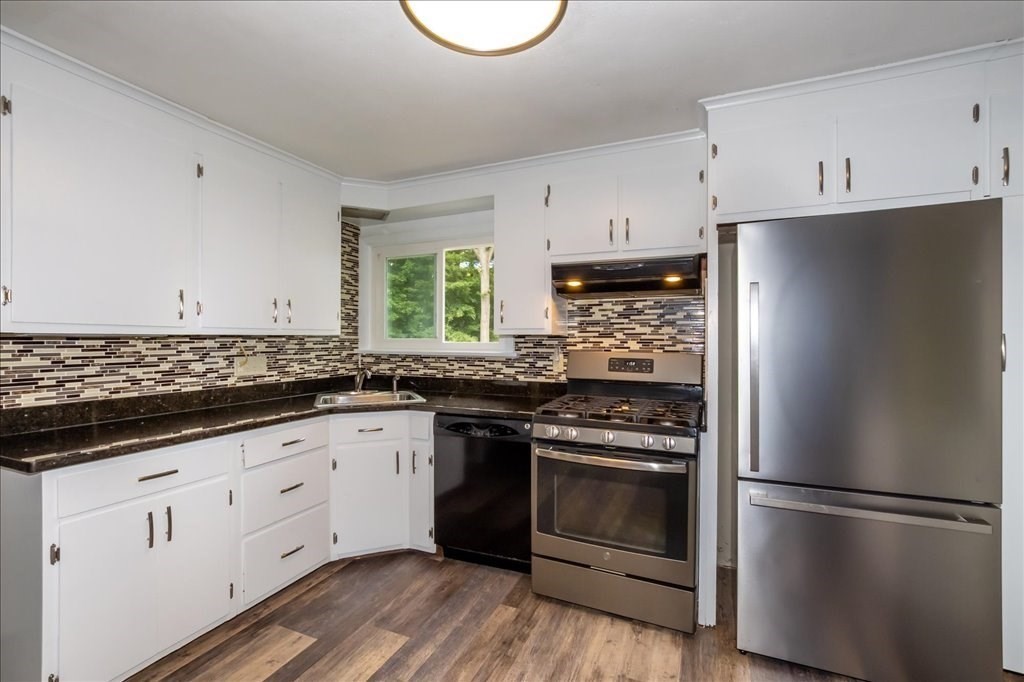 76 Woodland Road Longmeadow, MA 01106 - Photo 15 of 42 a kitchen with granite countertop white cabinets and stainless steel appliances