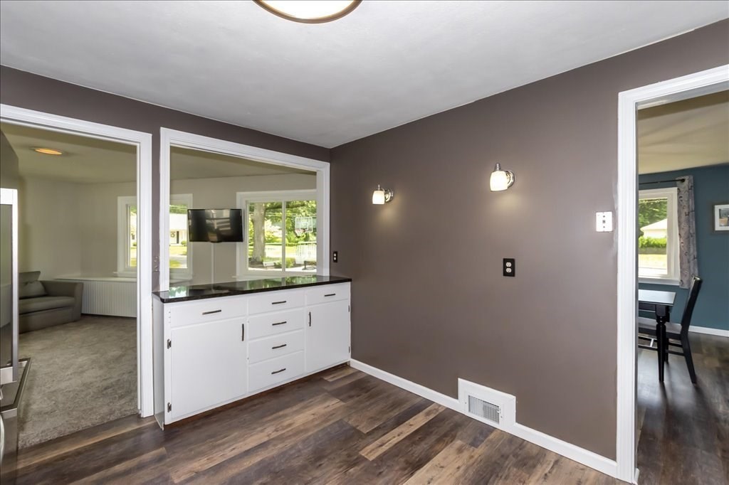76 Woodland Road Longmeadow, MA 01106 - Photo 16 of 42 wooden floor with a chair and a large mirror in a room