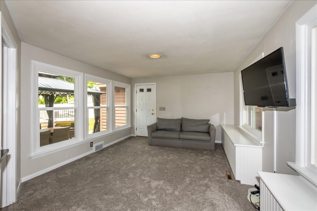 76 Woodland Road Longmeadow, MA 01106 - Photo 17 of 42 a living room with furniture and a flat screen tv