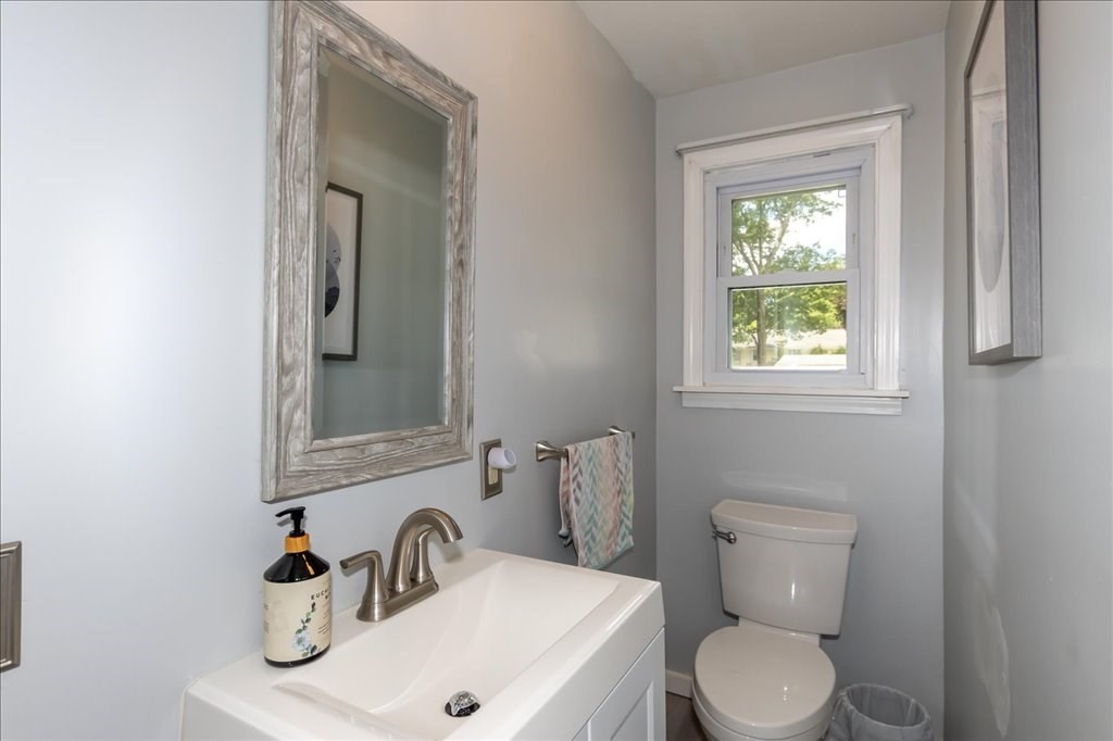 76 Woodland Road Longmeadow, MA 01106 - Photo 22 of 42 a bathroom with a sink a toilet and a mirror