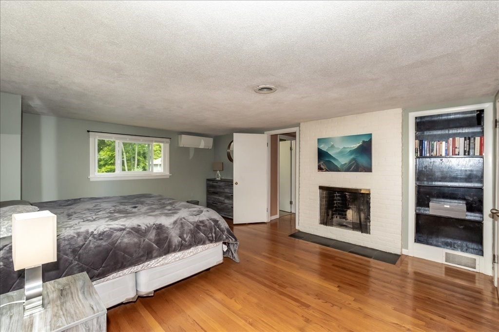 76 Woodland Road Longmeadow, MA 01106 - Photo 25 of 42 a bedroom with a bed and a fireplace