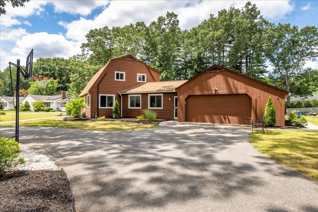 76 Woodland Road Longmeadow, MA 01106 - Photo 3 of 42 a front view of a house with a garden