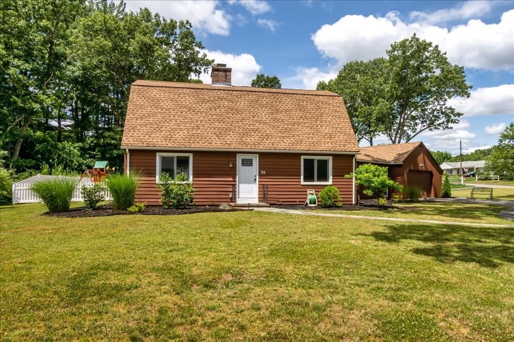 76 Woodland Road Longmeadow, MA 01106 - Photo 4 of 42 a front view of a house with a garden and tree