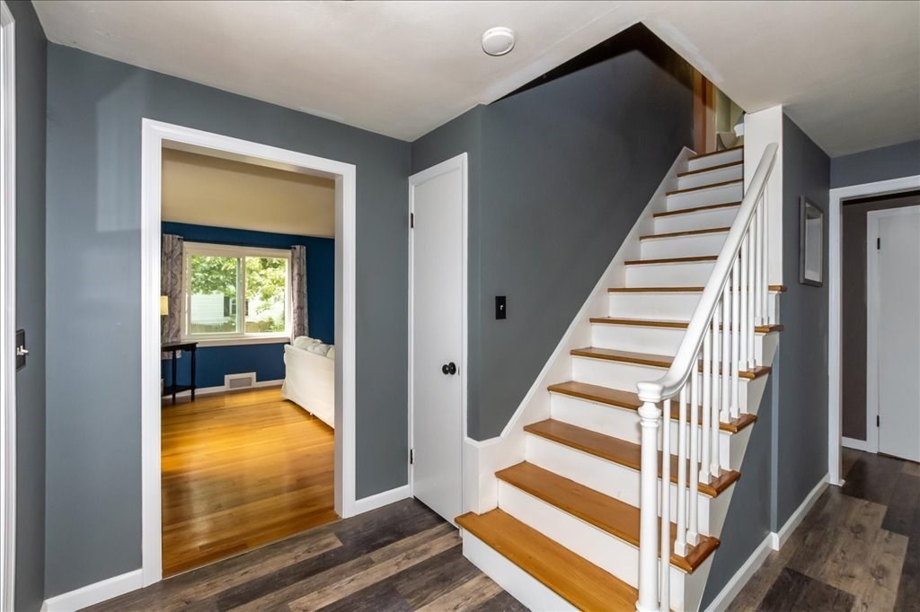 76 Woodland Road Longmeadow, MA 01106 - Photo 7 of 42 a view of a hallway with wooden floor and windows