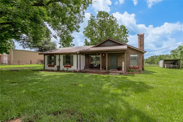 a front view of a house with a garden and porch