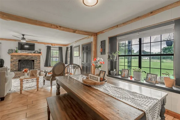 a dining room with fireplace furniture and a large window