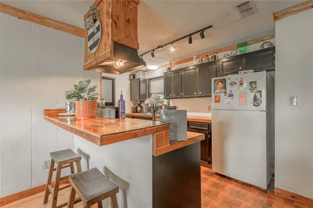 a kitchen with stainless steel appliances a sink and a refrigerator