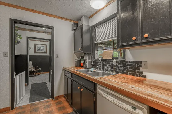 a kitchen with a sink and a refrigerator