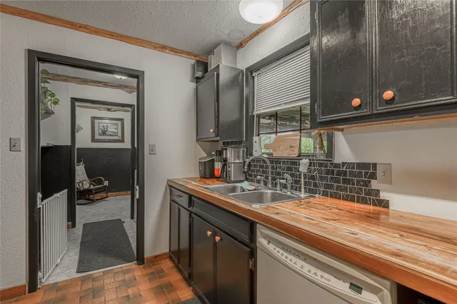 a kitchen with a sink and a refrigerator
