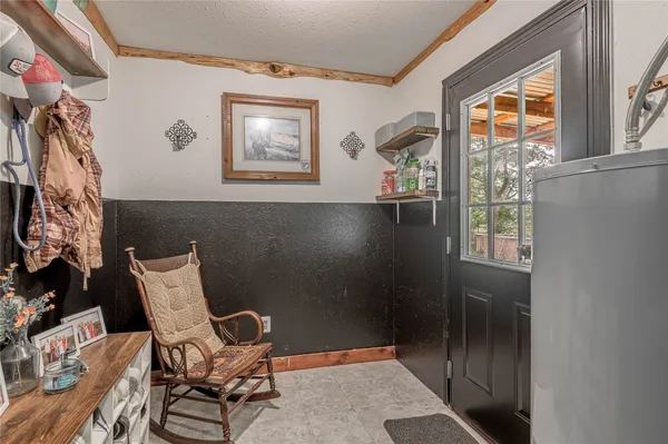 a view of a livingroom with lounge chair and windows
