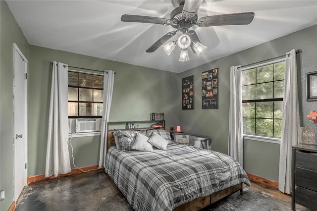 a bedroom with a large bed and a window