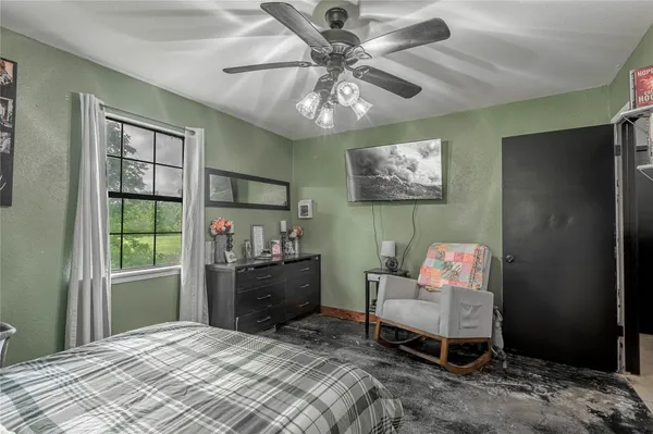 a bedroom with a bed and a window