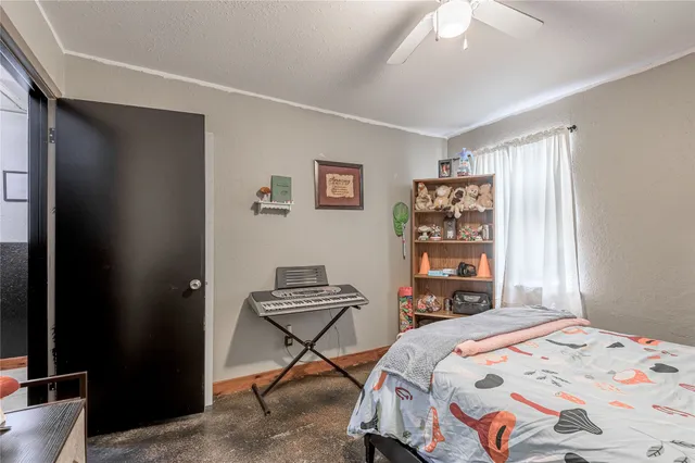 a bedroom that has a bed and a chair in it