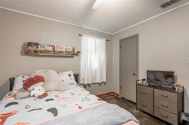 a bedroom with a bed and flat screen tv