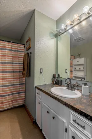 a bathroom with a double vanity sink and mirror