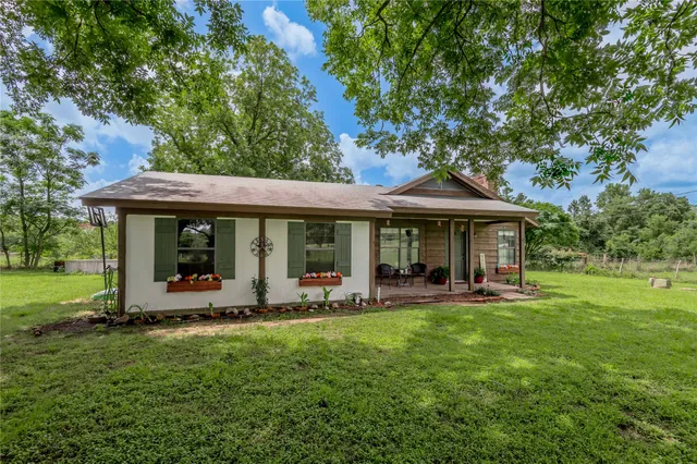 a front view of a house with a garden and porch