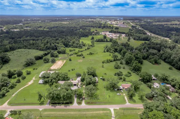 an aerial view of a house with a yard