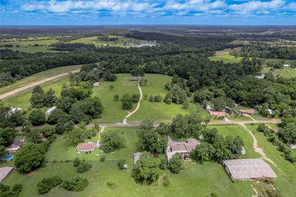 an aerial view of a houses with a yard