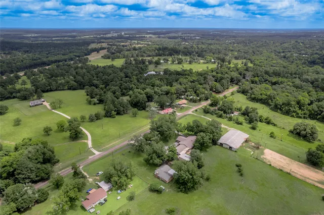 an aerial view of a house with lots of trees
