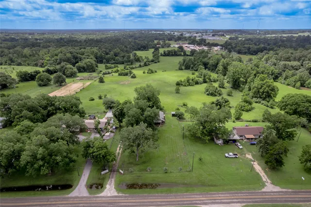 an aerial view of a house with a yard