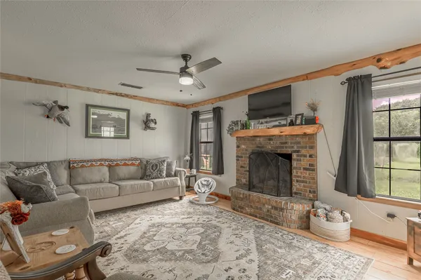 a living room with furniture a window and a fireplace
