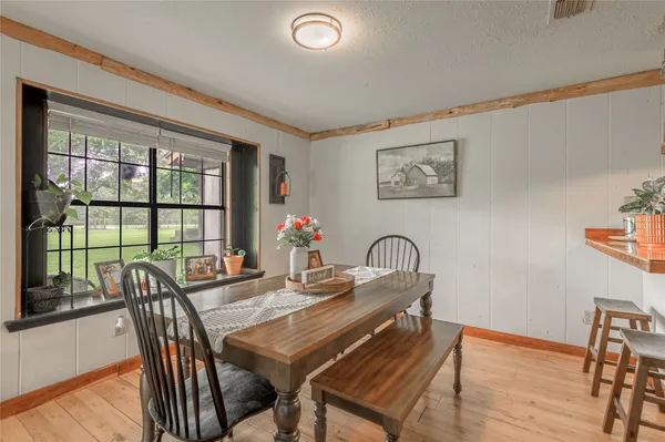 a dining room with furniture and wooden floor