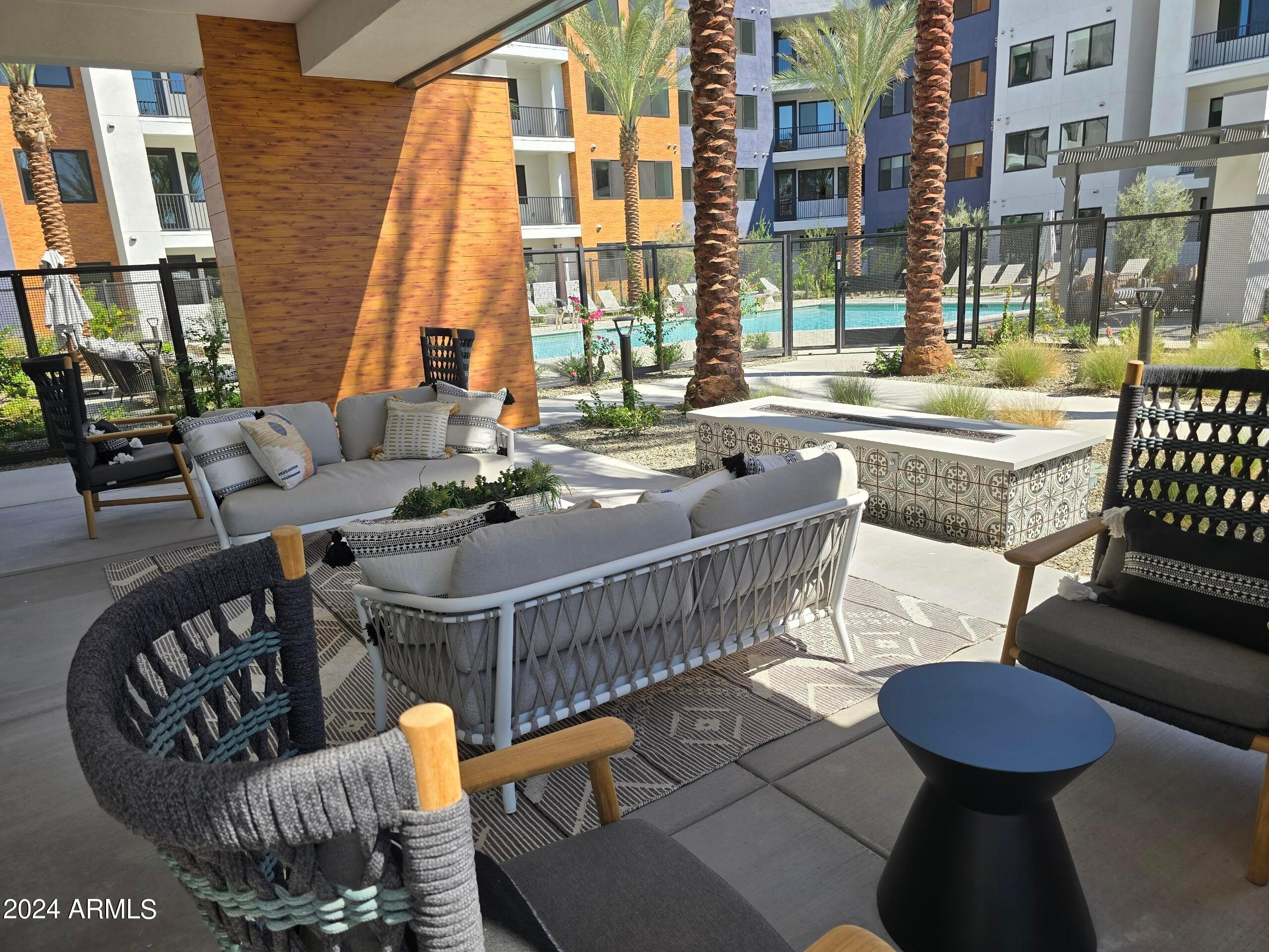 2500 East Marco Polo Road, Unit A1 Phoenix, AZ 85050 - Photo 12 of 15 a view of a patio with couches table and chairs and potted plants