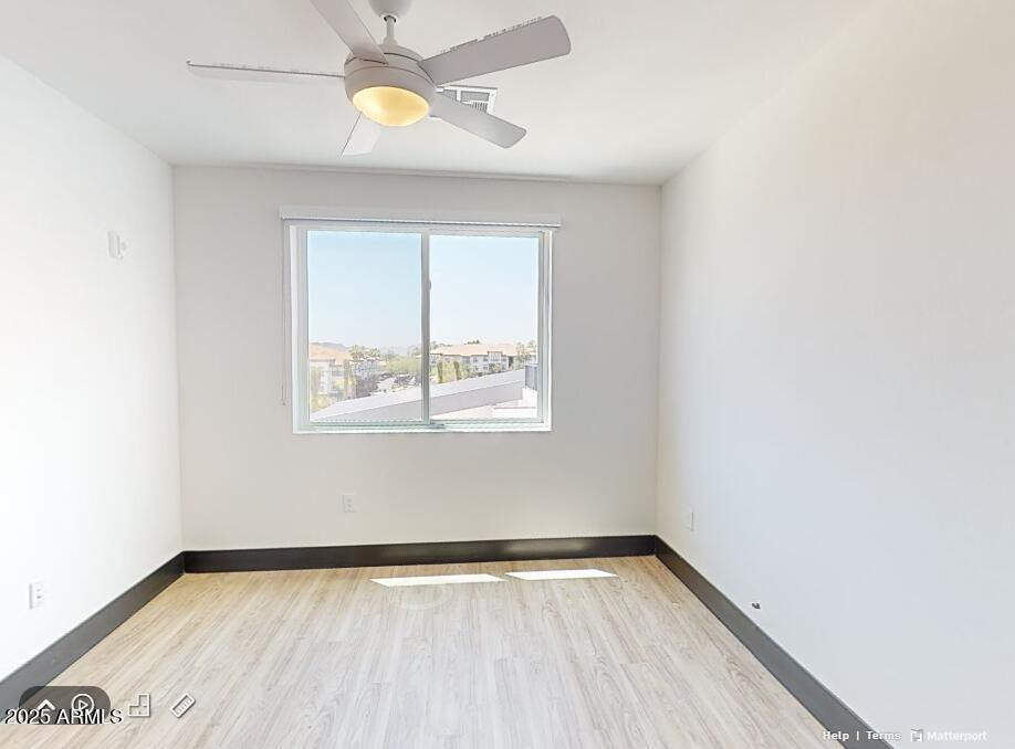 2500 East Marco Polo Road, Unit A1 Phoenix, AZ 85050 - Photo 4 of 15 a view of an empty room with window and wooden floor