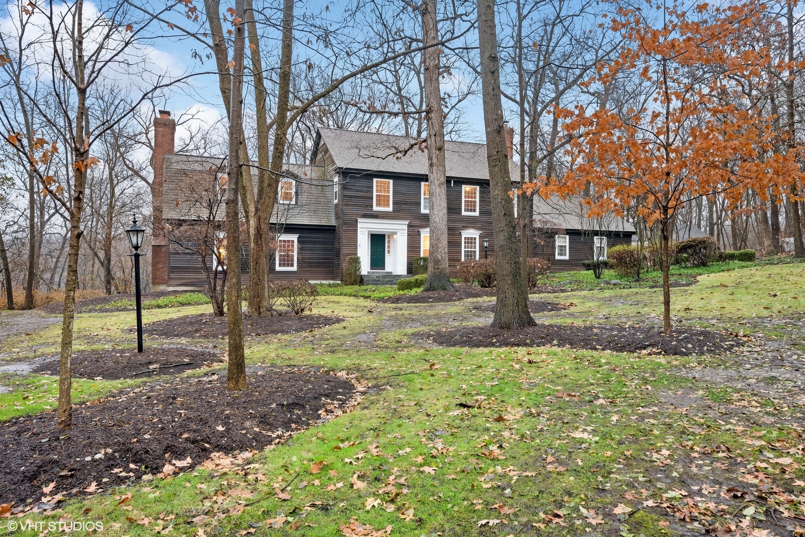 a view of a house with a yard and the trees