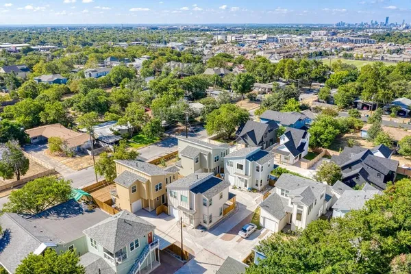 an aerial view of residential houses with outdoor space