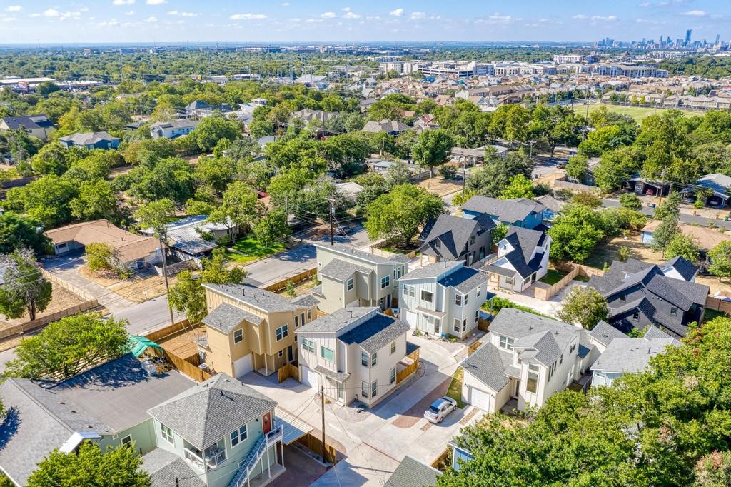 an aerial view of residential houses with outdoor space