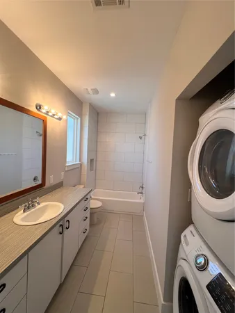 a spacious bathroom with a sink a mirror and a bathtub