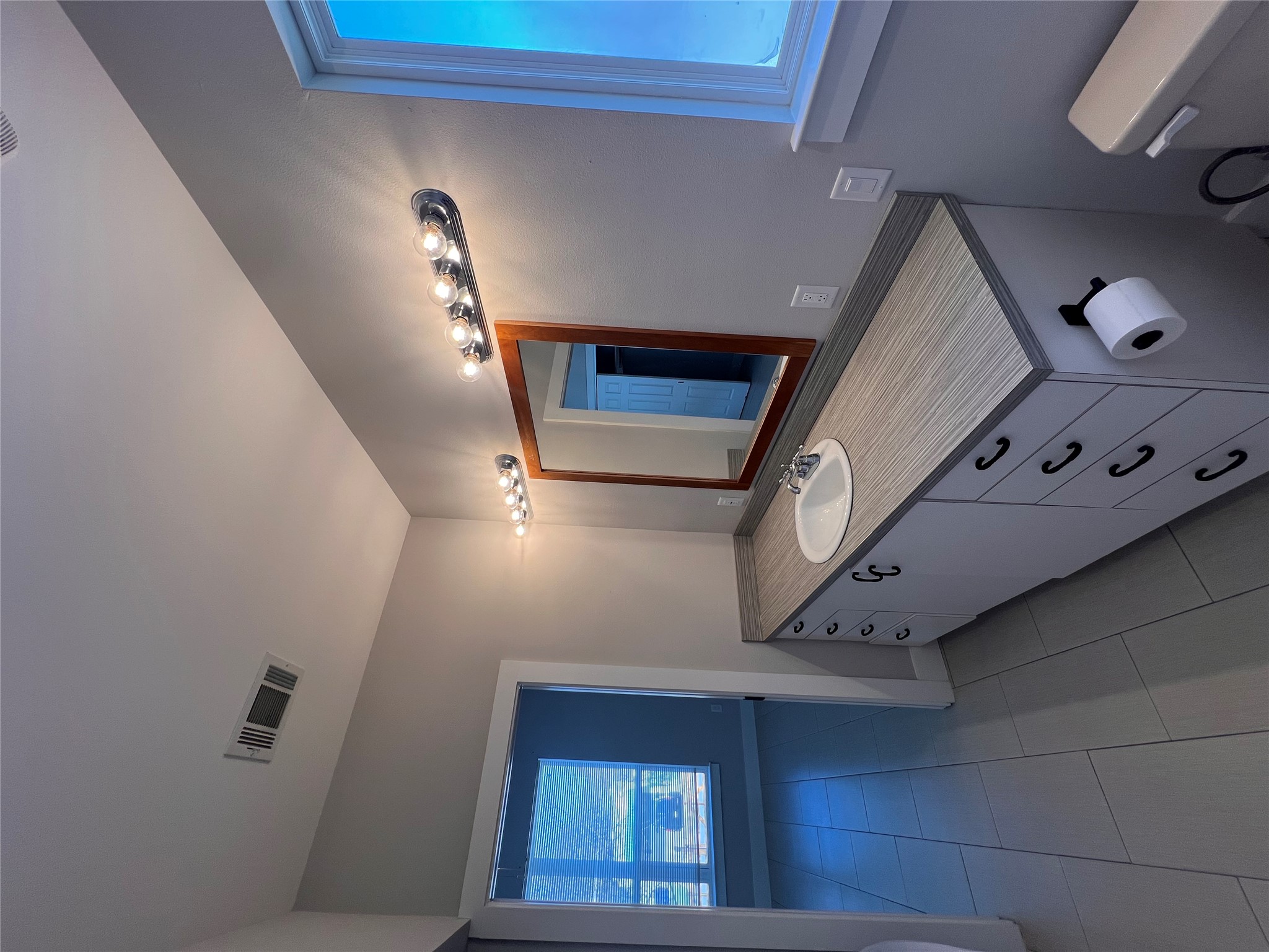 1101 Stobaugh Street, Unit B Austin, TX 78757 - Photo 15 of 21 a bathroom with a granite countertop sink a mirror and a toilet