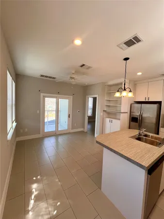 a kitchen with a sink a stove a microwave and cabinets
