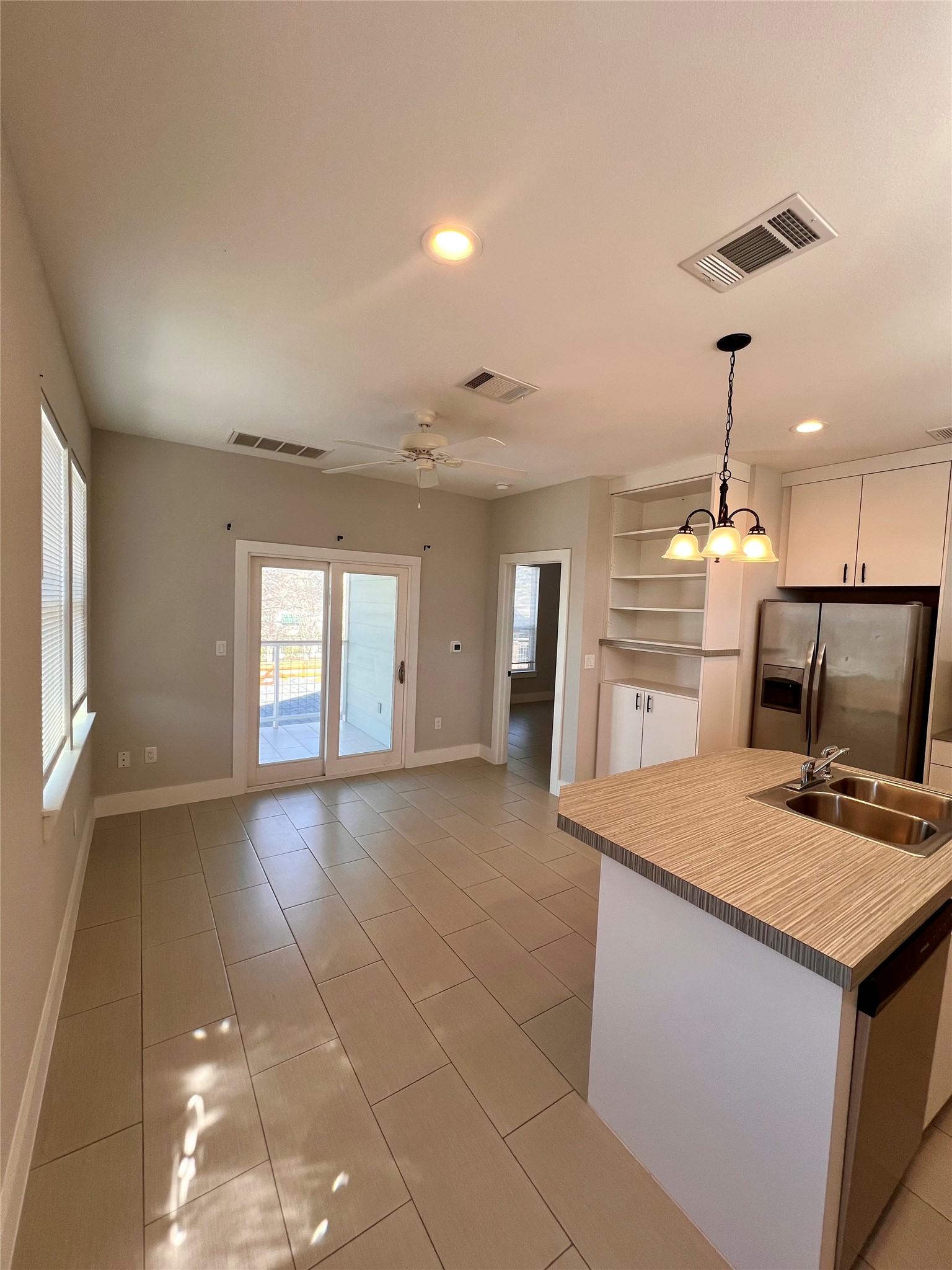 1101 Stobaugh Street, Unit B Austin, TX 78757 - Photo 4 of 21 a kitchen with a sink a stove a microwave and cabinets