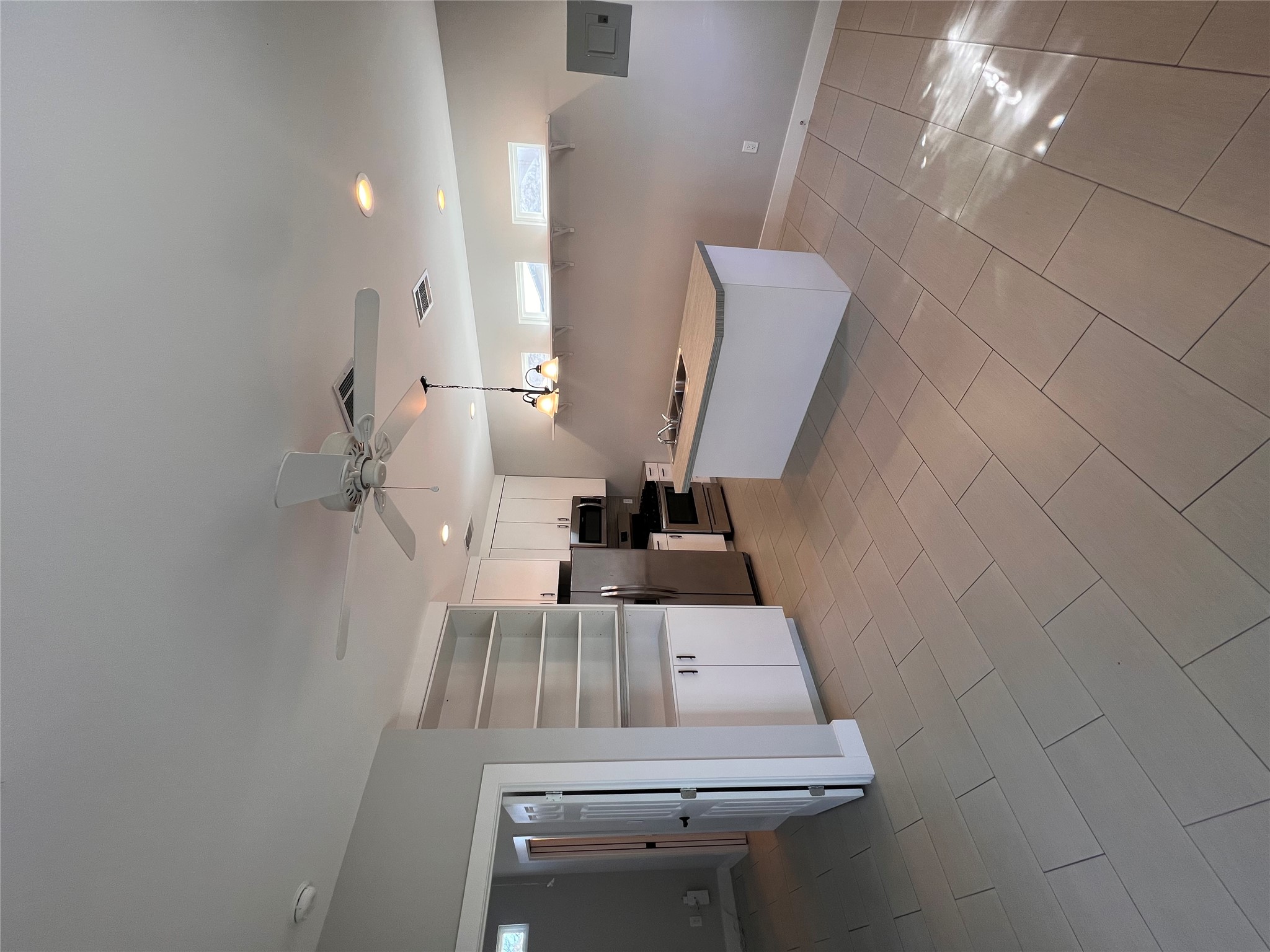 1101 Stobaugh Street, Unit B Austin, TX 78757 - Photo 8 of 21 a room with chandelier fan and kitchen view