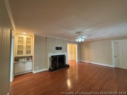 1513 Raeford Road Fayetteville, NC 28305 - Photo 9 of 25 an empty room with windows fireplace and a kitchen view