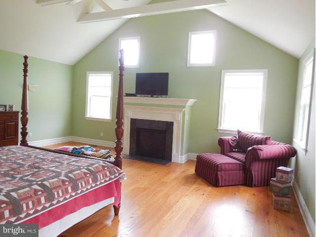 11601 Matthews Road Keymar, MD 21757 - Photo 21 of 30 a bedroom with a bed and a fireplace
