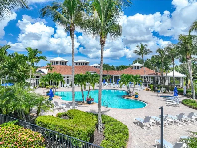 a view of a house with swimming pool and sitting area